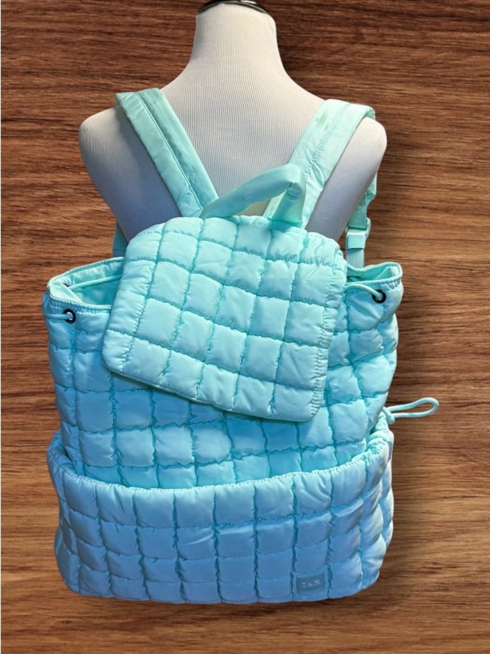 Iris Puff Backpack by Iris & Rainbow features a mint green quilted puffer design